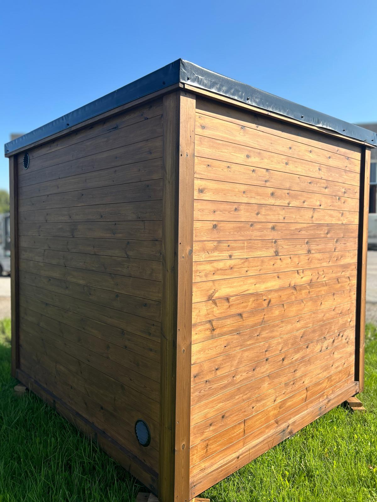Monarch King Traditional Outdoor Sauna on a field Back view