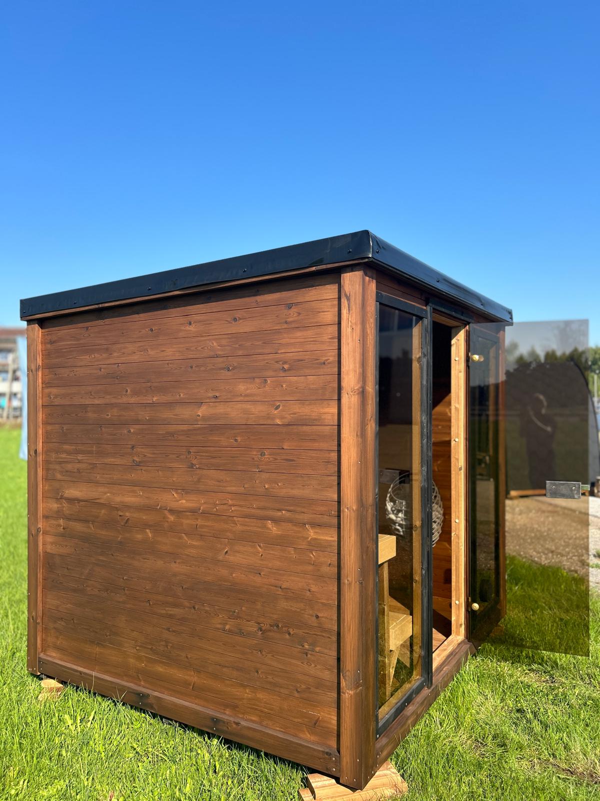 Grand Monarch Traditional Outdoor Sauna on a field Side view with its door open