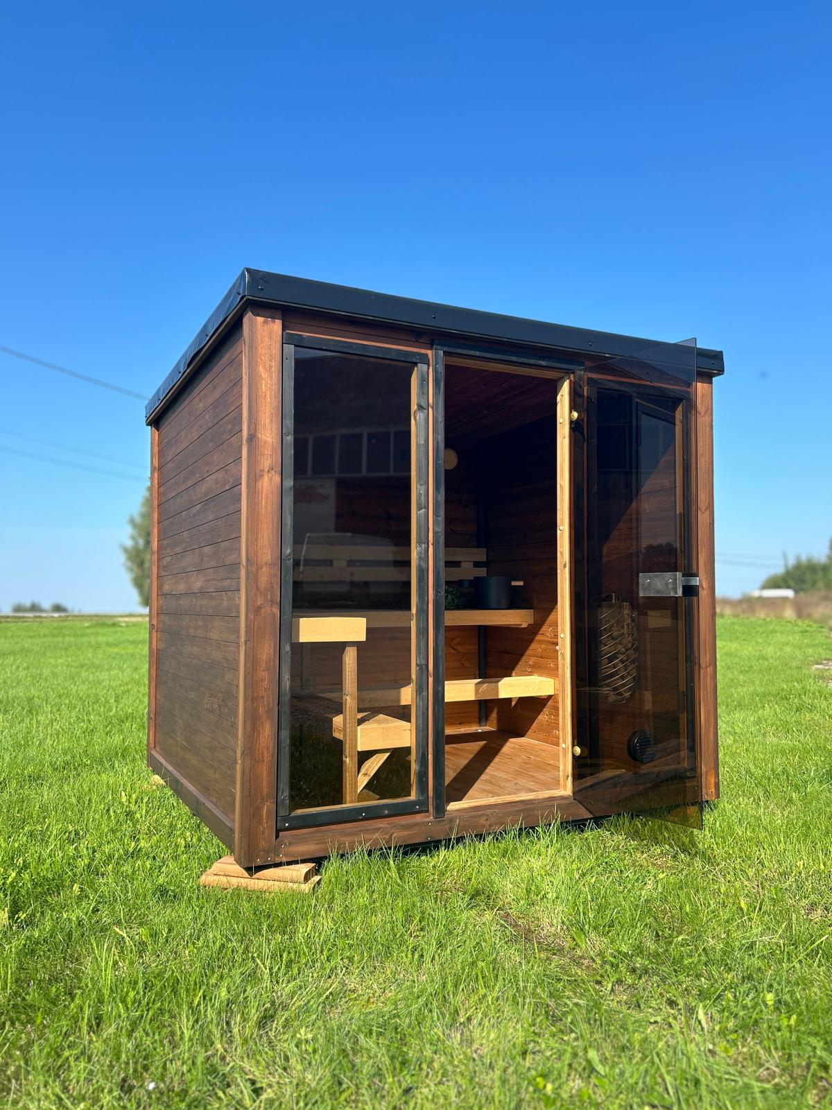 Grand Monarch Traditional Outdoor Sauna on a field Front view with its door open