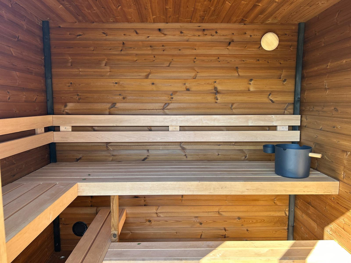 Grand Monarch Traditional Outdoor Sauna Interior view with a bucket laddle termometer