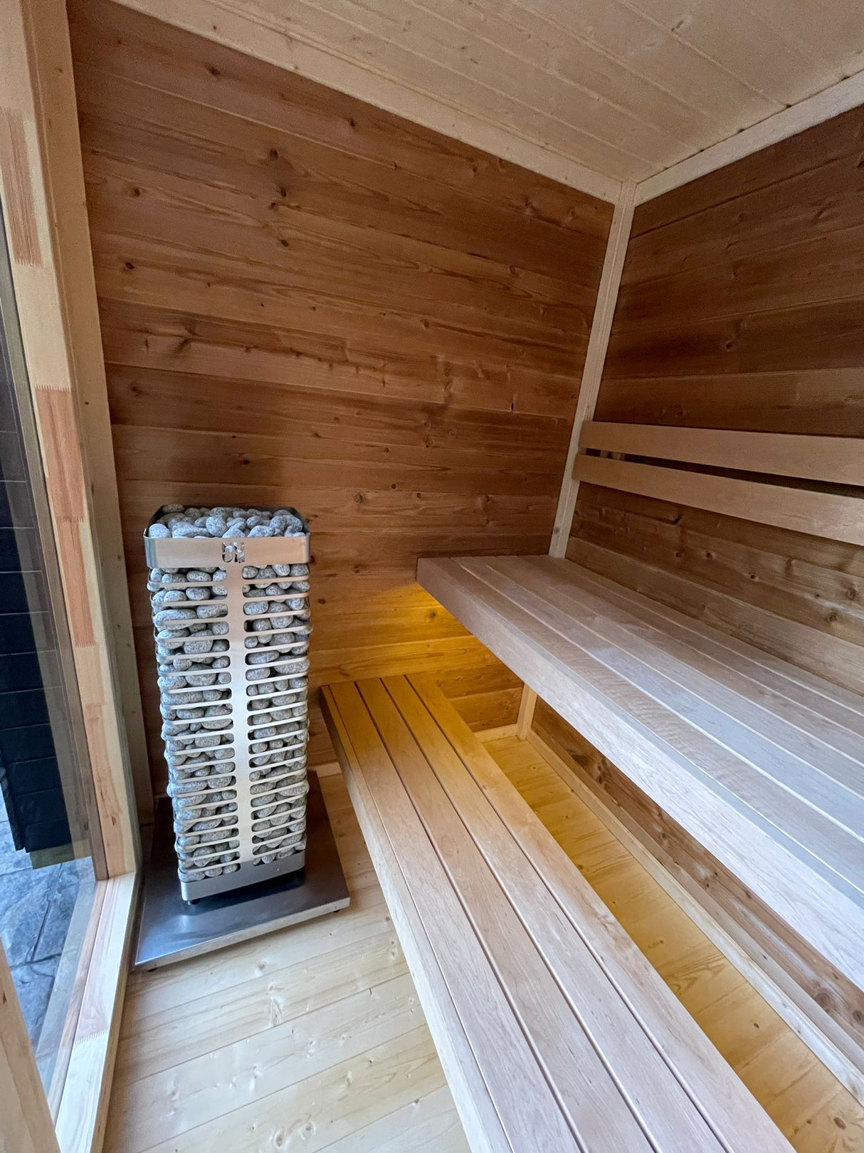 View from the interior of Flora Sauna looking to its seats and heater